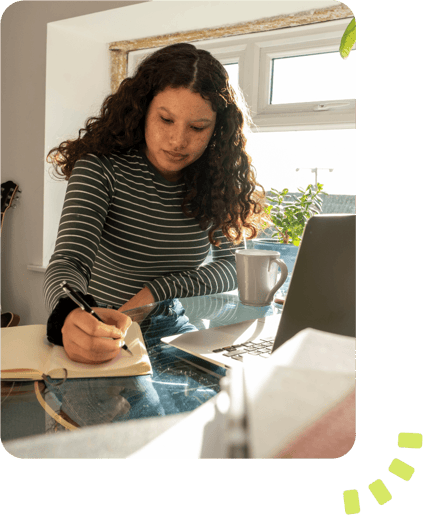 Woman sat at her desk in front of her laptop