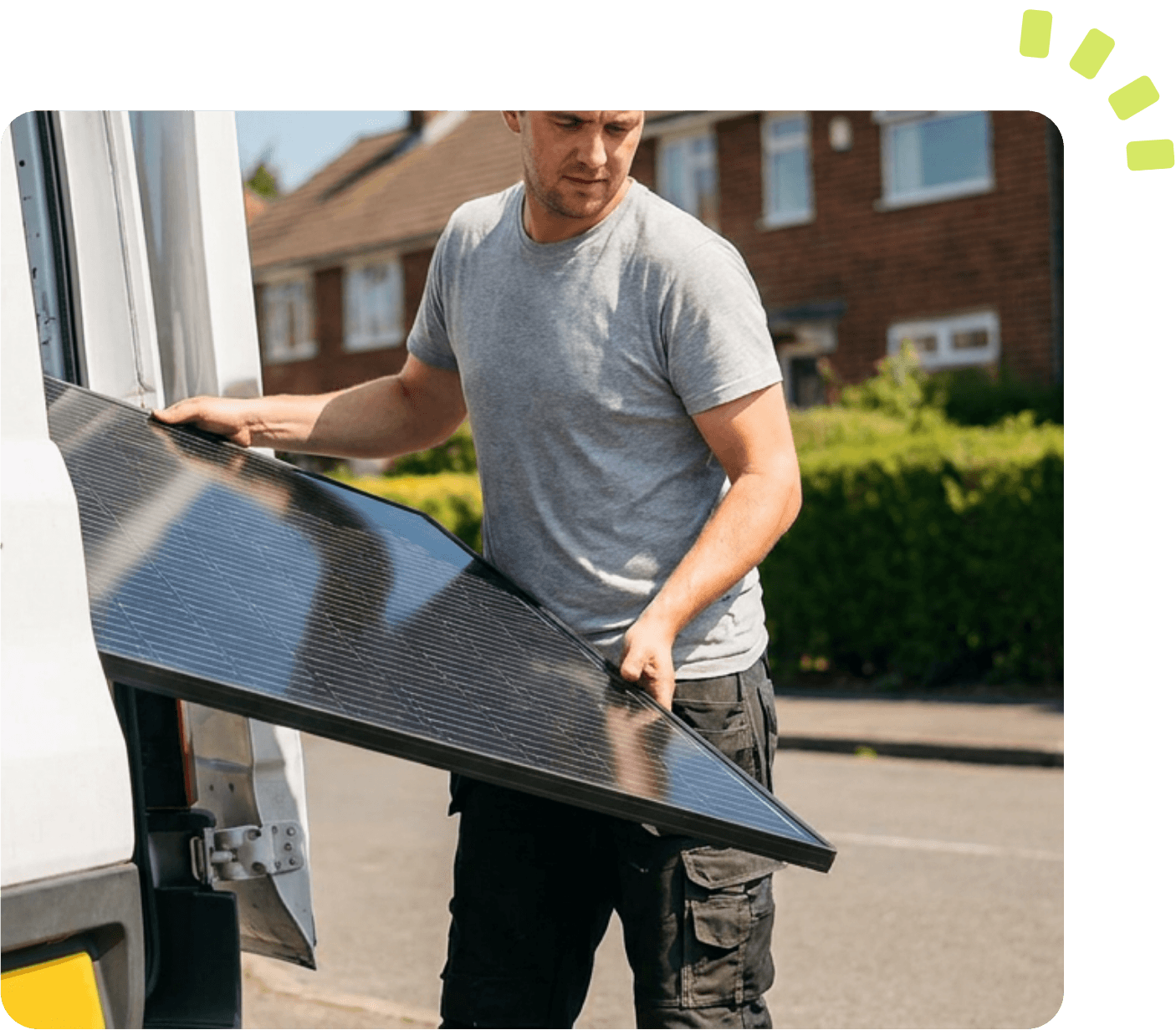Man lifting solar panel out of van